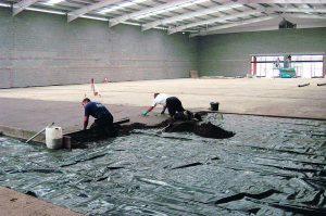 Applying screed on a warehouse floor